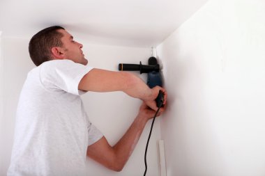 Man drilling a ceiling clipart