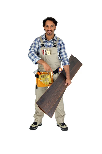 Woodworker apontando para piso laminado — Fotografia de Stock
