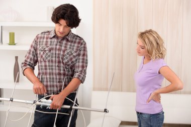 A man repairing a TV roof antenna clipart