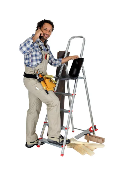 Carpenter with laptop and cellphone — Stock Photo, Image
