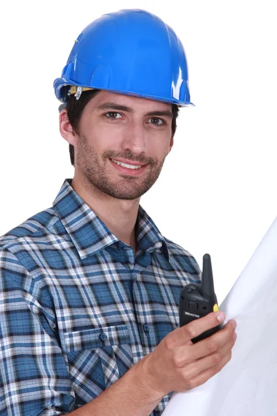 Foreman holding radio and plans — Stock Photo, Image