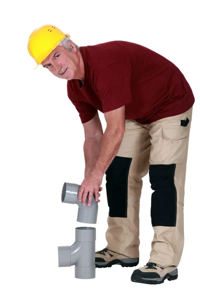 Plumber connecting two parts — Stock Photo, Image