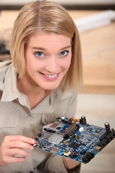 stock image Woman repairing an electronic component