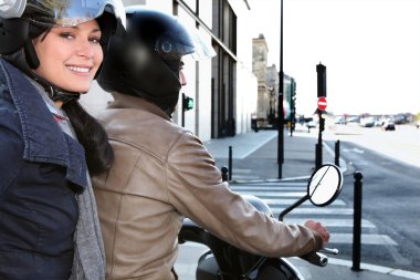 Trendy couple on a moped clipart