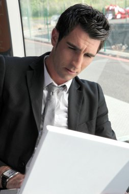 Businessman working on computer clipart