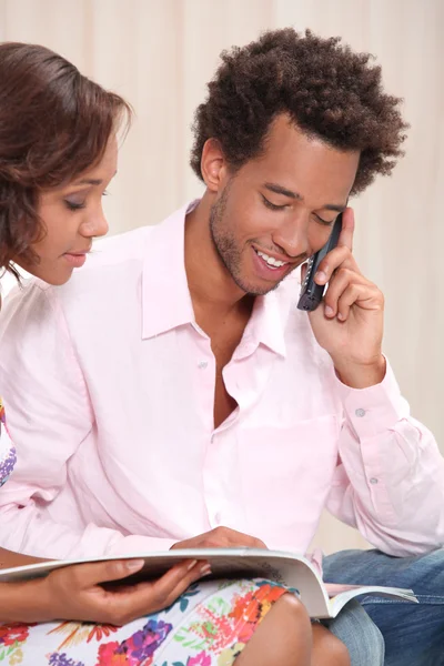 Young man at phone and his girlfriend — Stock Photo, Image