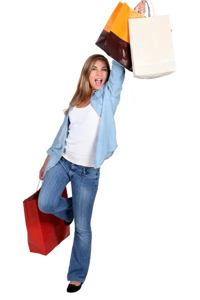 Jonge vrouw met winkel zakken opgewonden — Stockfoto