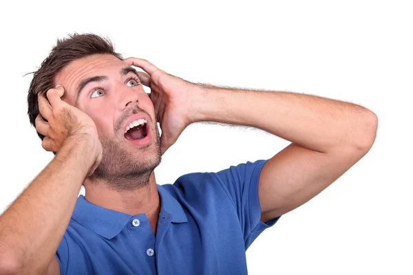 Man with his hands on his head shouting — Stock Photo, Image