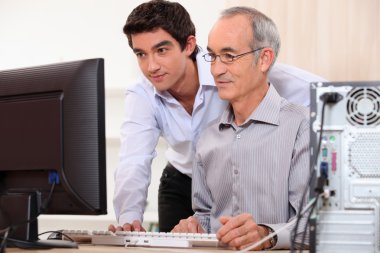 Computer technician helping office worker clipart