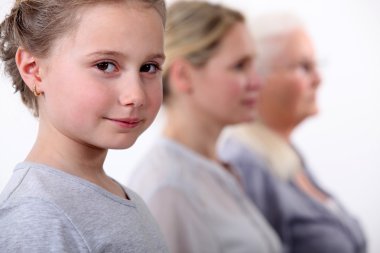 Little girl with mother and grandmother standing in line clipart