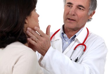 Woman being treated by doctor clipart