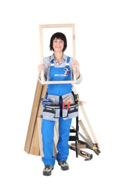 Female carpenter with a wooden frame clipart