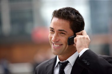 Handsome businessman having phone call clipart