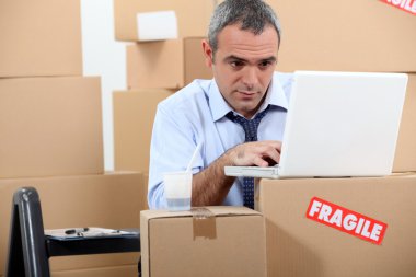 Man surrounded by boxes clipart