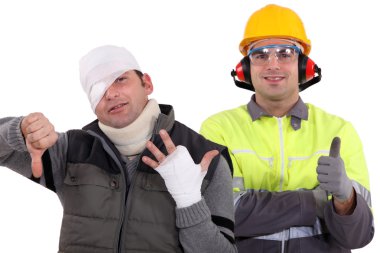 Healthy construction worker standing next to an injured man clipart