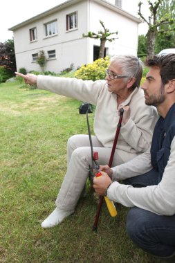 Young man and older woman in garden clipart