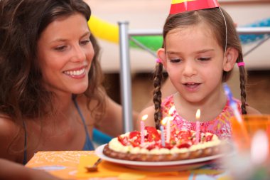 Girl blowing out candles clipart