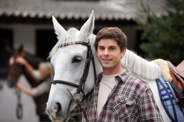 Portrait of a young man with horse clipart