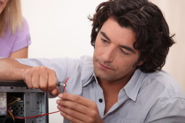 Man fixing a hard drive clipart