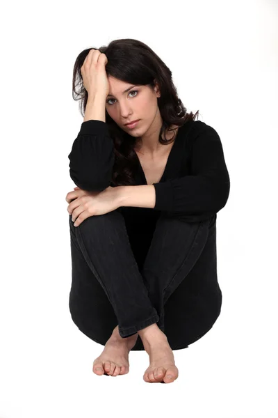 Woman sitting pensively — Stock Photo, Image