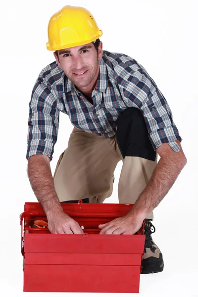 A handyman looking through his toolbox. — Stock Photo, Image