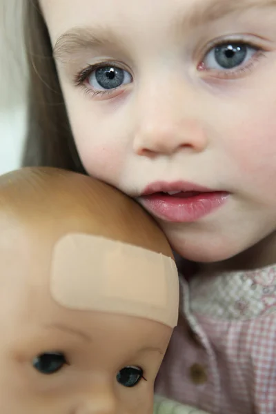 Little girl holding doll — Stock Photo, Image