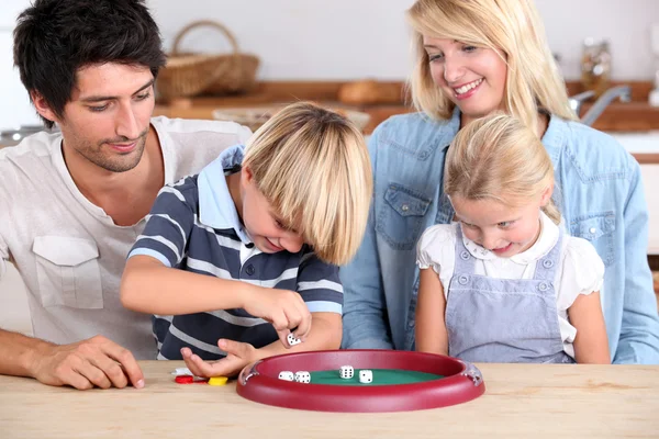 Familjen spelar en tärning spel — Stockfoto