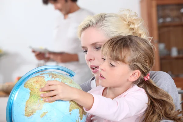 Huisvrouw met kind en globe — Stockfoto