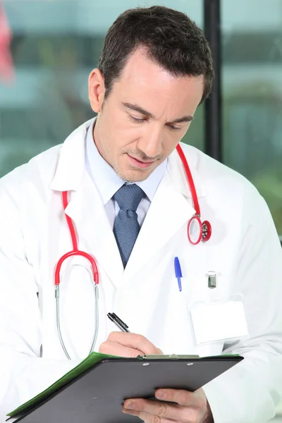 A doctor writing a prescription — Stock Photo, Image