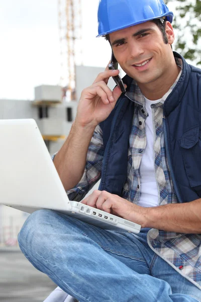 Foreman with mobile and laptop — Stock Photo, Image