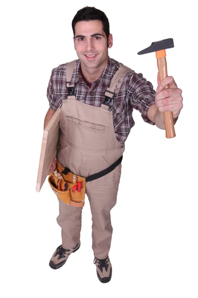 Tradesman holding up a tool — Stock Photo, Image