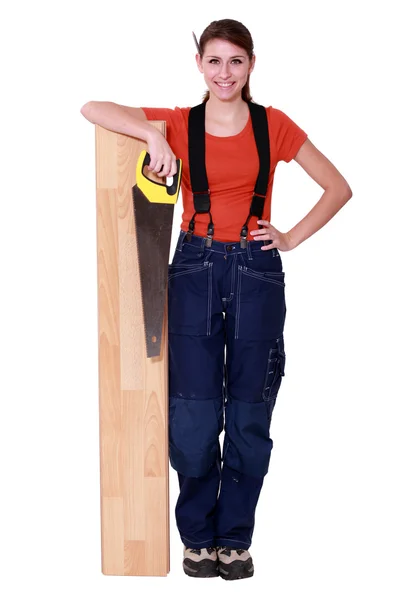 Woman sawing a plank of wood — Stock Photo, Image