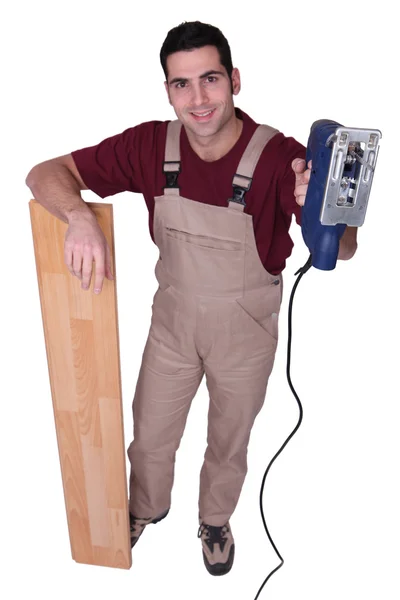 Joiner with parquet strips and sander machine — Stock Photo, Image