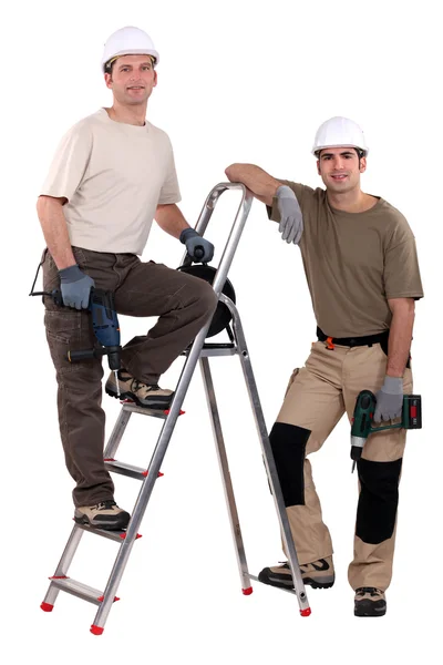 Zwei Arbeiter posieren mit Bohrern — Stockfoto