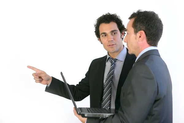 Two businessmen stood with laptop — Stock Photo, Image