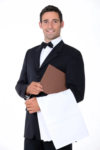 Well-dressed waiter holding menu — Stock Photo, Image