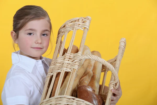 Girl with a basket of baguettes — Stock Photo, Image