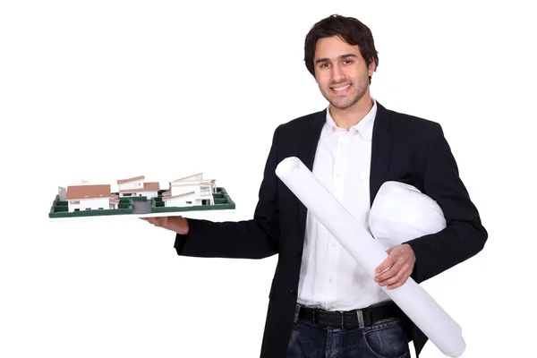 Architect holding scale model of housing — Stock Photo, Image