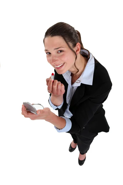 Businesswoman applying lipstick — Stock Photo, Image