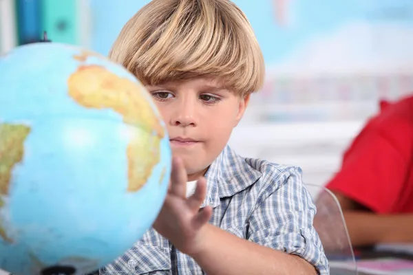 Portrait of a pupil with globe — Stock Photo, Image