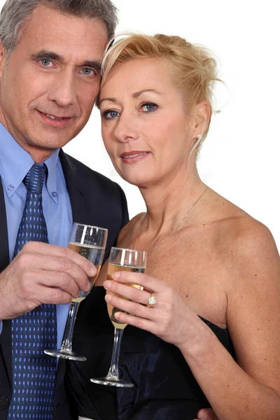 Ältere Paare stoßen mit Champagner an. — Stockfoto