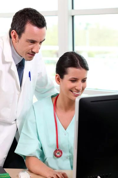 Doctor with his assistant — Stock Photo, Image