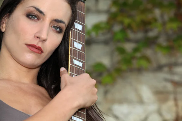 Woman outdoors with guitar Royalty Free Stock Images