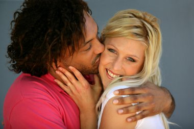 Romantic couple kissing at the beach clipart