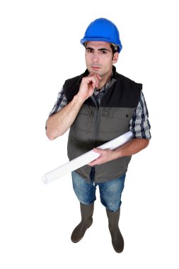 Architect holding rolled-up plans clipart