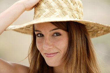 Attractive woman wearing straw hat clipart