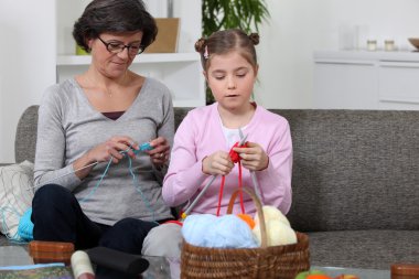 Mother and daughter knitting clipart