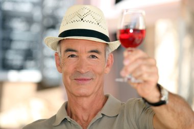 Old man raising a glass of claret clipart