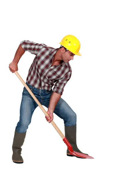 Laborer digging, studio shot — Stock Photo, Image