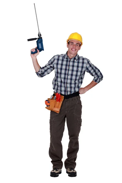 Young craftsman holding a drill — Stock Photo, Image